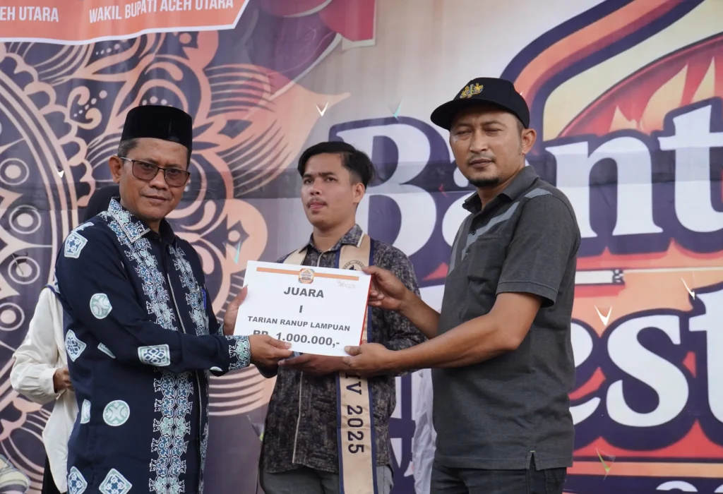 Foto: Kepala Disporapar Aceh Utara, M. Nasir, S.STP menyerakan tropi dan uang pembinaan kepada para pemenang