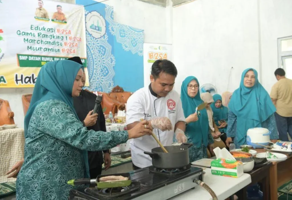 Foto: Pj Ketua Tim Penggerak PKK Aceh Mellani Subarni, melakukan demo masak kimbab tuna kari Aceh bersama chef Surya 14 besar Master Chef Indonesia season 6 dalam program Pangan Beragam, Bergizi, Seimbang dan Aman atau B2SA, di Dayah Ruhul Falah Samahani, Kecamatan Kuta Malaka, Aceh Besar, Selasa, (7/5/2024) .