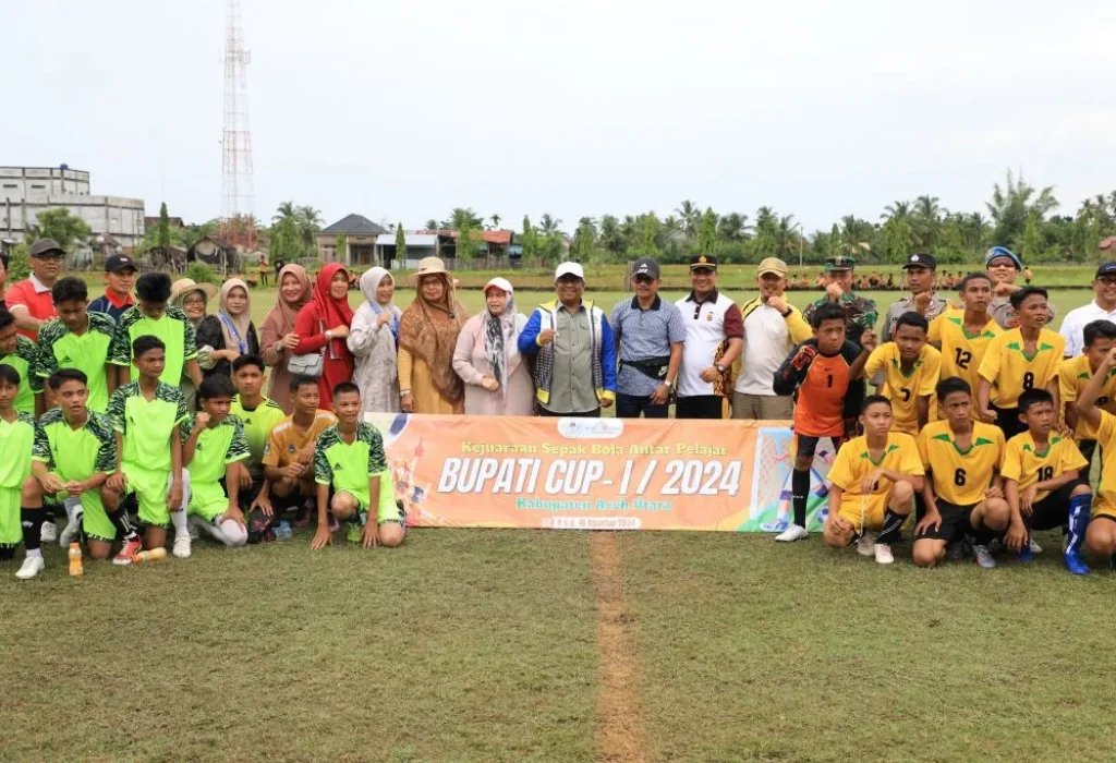 Foto: Penjabat (Pj) Bupati Aceh Utara, Dr. Mahyuzar, M.Si, bersama ibu Pj. TP-PKK, Ny. Awirdalina, dan didampingi oleh Kepala Dinas Kepemudaan dan Olahraga (Dispora), M. Nasir, S.Sos, M.Si meninjau langsung pertandingan kejuaraan sepak bola antar pelajar Bupati Cup I Tahun 2024, Sabtu, 10 Agustus 2024. Kegiatan tersebut berlangsung di lapangan bola kaki Kecamatan Syamtalira Aron.